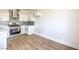 Bright kitchen with stainless steel appliances, sleek white cabinetry, and wood-look floors at 2110 Los Feliz St # 1003, Las Vegas, NV 89156