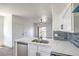 Bright kitchen with stainless steel appliances, quartz countertops, and open to the living area at 2110 Los Feliz St # 1003, Las Vegas, NV 89156