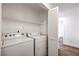 Laundry room featuring a washer, dryer, and shelving for storage at 2110 Los Feliz St # 1003, Las Vegas, NV 89156