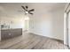 Bright open floor plan with wood-look floors, kitchen island, and access to a balcony at 2110 Los Feliz St # 1003, Las Vegas, NV 89156