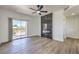 Open-concept living space with wood floors, decorative fireplace, and balcony access with sliding doors at 2110 Los Feliz St # 1003, Las Vegas, NV 89156
