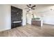 Open living space featuring modern fireplace, kitchen island with wooden accents, and ceiling fans at 2110 Los Feliz St # 1003, Las Vegas, NV 89156