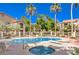 Community pool and hot tub surrounded by lounge chairs, trees, and well-maintained landscaping at 2110 Los Feliz St # 1003, Las Vegas, NV 89156