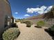 Landscaped backyard featuring decorative rock, shrubs, and a sturdy privacy wall for peaceful outdoor living at 2224 Waterton Rivers Dr, Henderson, NV 89044