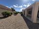 Spacious backyard featuring decorative rock landscaping, providing a low-maintenance and stylish outdoor area at 2224 Waterton Rivers Dr, Henderson, NV 89044