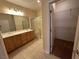 Bathroom featuring double sinks, a walk-in shower, and a convenient walk-in closet at 2224 Waterton Rivers Dr, Henderson, NV 89044