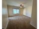 Cozy bedroom with neutral paint, carpet, a ceiling fan, and a view of the outdoor landscape at 2224 Waterton Rivers Dr, Henderson, NV 89044