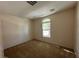 Comfortable bedroom featuring neutral carpet, with a window providing natural light and a serene view at 2224 Waterton Rivers Dr, Henderson, NV 89044