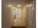 Inviting hallway with neutral paint and tile flooring, leading to various rooms in the home at 2224 Waterton Rivers Dr, Henderson, NV 89044