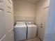 Convenient laundry room with washer, dryer, and shelving for organized and efficient home management at 2224 Waterton Rivers Dr, Henderson, NV 89044