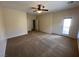 Carpeted main bedroom featuring a ceiling fan, two entry doors, and private outdoor access at 2224 Waterton Rivers Dr, Henderson, NV 89044