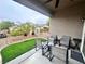 A cozy back patio offers synthetic turf, desert landscaping, and a comfortable seating area at 2558 Divine Sky Dr, Henderson, NV 89044