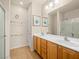 Bright bathroom with dual sinks, mirror, and shower at 2558 Divine Sky Dr, Henderson, NV 89044