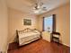 Cozy bedroom with wood floors, a ceiling fan, and a window providing natural light at 2558 Divine Sky Dr, Henderson, NV 89044