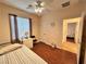 Comfortable bedroom featuring wood floors, ceiling fan, and natural light from a window at 2558 Divine Sky Dr, Henderson, NV 89044