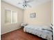 Bright bedroom featuring wood floors, ceiling fan, bed, and a bedside table with a lamp at 2558 Divine Sky Dr, Henderson, NV 89044