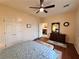 Bedroom with wood floors, ceiling fan, and a large dresser with mirror at 2558 Divine Sky Dr, Henderson, NV 89044