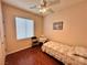 Comfortable bedroom with wood floors, a ceiling fan, and natural light at 2558 Divine Sky Dr, Henderson, NV 89044