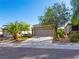 A beautifully landscaped single-story home showcasing mature trees and a two-car garage at 2558 Divine Sky Dr, Henderson, NV 89044