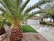 Inviting single-story residence with lush landscaping, artificial grass, and a spacious driveway at 2558 Divine Sky Dr, Henderson, NV 89044