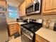Well-lit kitchen featuring stainless steel appliances, wooden cabinetry, and sleek countertops at 2558 Divine Sky Dr, Henderson, NV 89044