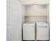 A closet featuring a front-loading washing machine, a front-loading dryer, and a shelf at 2558 Divine Sky Dr, Henderson, NV 89044