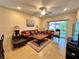 Comfortable living room features tile flooring, ceiling fan, and sliding glass door to backyard at 2558 Divine Sky Dr, Henderson, NV 89044