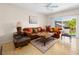 Cozy living room with tile flooring and an adjacent glass sliding door that allows plenty of natural light at 2558 Divine Sky Dr, Henderson, NV 89044