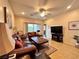 Inviting living room with tile floors, ceiling fan, and a view of the backyard at 2558 Divine Sky Dr, Henderson, NV 89044