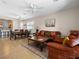 Bright and open living room with tile flooring and comfortable seating that leads to the dining area and kitchen at 2558 Divine Sky Dr, Henderson, NV 89044