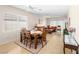 Inviting living room with tile floors, lots of windows, and comfortable seating around the wooden dining table at 2558 Divine Sky Dr, Henderson, NV 89044
