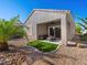 Beautiful outdoor patio with synthetic grass, gravel and outdoor seating area at 2558 Divine Sky Dr, Henderson, NV 89044
