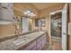 Bright bathroom with dual sinks, granite counters, modern lighting, and a glass-enclosed shower at 2725 S Nellis Blvd # 2052, Las Vegas, NV 89121