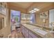 Bathroom with granite countertops, dual sinks, and adjacent bedroom view at 2725 S Nellis Blvd # 2052, Las Vegas, NV 89121