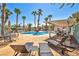 Beautiful pool area with lounge chairs and lush landscaping with palm trees at 2725 S Nellis Blvd # 2052, Las Vegas, NV 89121