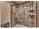 Walk-in shower with brown marble tile and glass door at 2725 S Nellis Blvd # 2052, Las Vegas, NV 89121