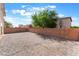 Backyard featuring stone landscaping and brick perimeter wall at 2833 Swanson Ave, North Las Vegas, NV 89086