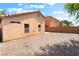 Exterior of home featuring a spacious gravel backyard and privacy wall at 2833 Swanson Ave, North Las Vegas, NV 89086