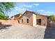 A large, gravel backyard with privacy walls and a small concrete patio area at 2833 Swanson Ave, North Las Vegas, NV 89086