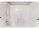 Bright bathroom featuring white tile surround, shower head, and faucet at 2833 Swanson Ave, North Las Vegas, NV 89086