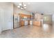 Open kitchen with tile floors, stainless steel refrigerator, and adjacent living area at 2833 Swanson Ave, North Las Vegas, NV 89086