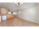 Open-concept kitchen with tile flooring, stainless steel appliances and breakfast bar overlooking living area at 2833 Swanson Ave, North Las Vegas, NV 89086