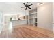 An open living area with built-in shelving, tile and wood laminate flooring, ceiling fan and neutral paint at 2833 Swanson Ave, North Las Vegas, NV 89086