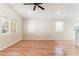A spacious living room with a ceiling fan and large windows offering plenty of natural light at 2833 Swanson Ave, North Las Vegas, NV 89086