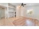 An open living area with built-in shelving, tile and wood laminate flooring, ceiling fan and neutral paint at 2833 Swanson Ave, North Las Vegas, NV 89086