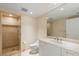Bright bathroom featuring a glass shower, white vanity with marble countertop and gold hardware at 2857 Paradise Rd # 802, Las Vegas, NV 89109