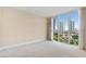 Bright bedroom featuring carpet, neutral walls, and a large window with views of the city at 2857 Paradise Rd # 802, Las Vegas, NV 89109