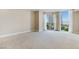 Bright bedroom with neutral carpet, base trim and a sliding glass door leading to a balcony at 2857 Paradise Rd # 802, Las Vegas, NV 89109