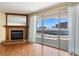 Close-up of hardwood floor living room with fireplace and sliding glass doors to a balcony at 2857 Paradise Rd # 802, Las Vegas, NV 89109
