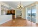 Spacious living room with hardwood floors, chandelier and sliding glass doors to a balcony with city views at 2857 Paradise Rd # 802, Las Vegas, NV 89109